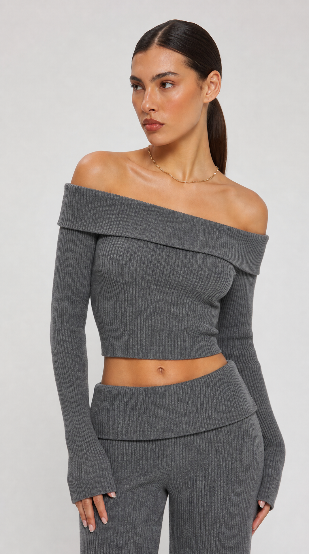 Grey two-piece off-shoulder knit top and flared trousers set